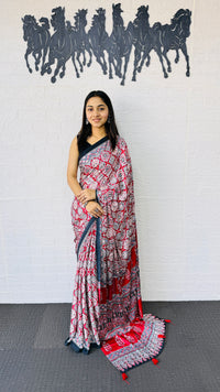 Vibrant Red Ajrakh-Inspired Printed Saree with Traditional Border & Tassel Detailing