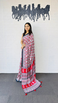 Vibrant Red Ajrakh-Inspired Printed Saree with Traditional Border & Tassel Detailing