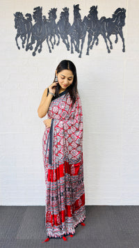 Vibrant Red Ajrakh-Inspired Printed Saree with Traditional Border & Tassel Detailing