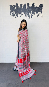 Vibrant Red Ajrakh-Inspired Printed Saree with Traditional Border & Tassel Detailing