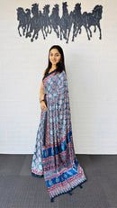 Graceful Indigo Blue Ajrakh-Inspired Printed Saree with Ethnic Border & Tassel Detailing