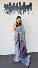 Graceful Indigo Blue Ajrakh-Inspired Printed Saree with Ethnic Border & Tassel Detailing