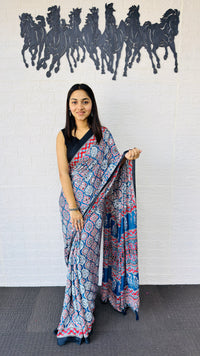 Graceful Indigo Blue Ajrakh-Inspired Printed Saree with Ethnic Border & Tassel Detailing