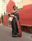Luxury Black Linen Saree with Ajrakh-Inspired Red Prints & Classic Stripe Pallu