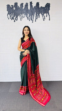 Elegant Bottle Green Designer Saree with Vibrant Red Folk Art Pallu