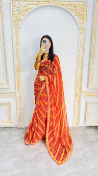 Fiery Orange Leheriya Print Saree with Elegant Embroidered Lace Border